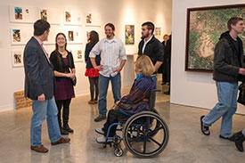 Mason students attend an art gallery show opening