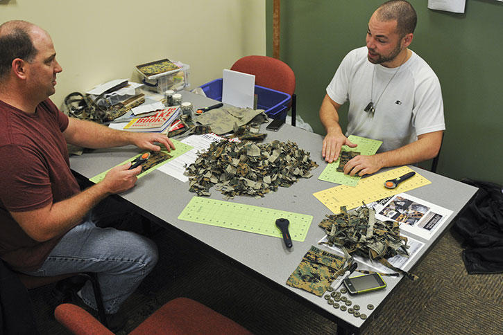Mason Veteran Students work with pieces of old uniform