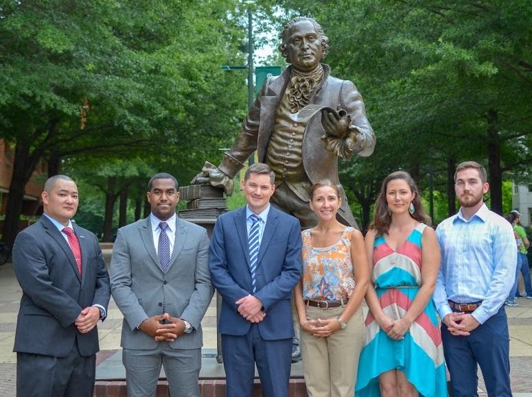 The OMS team in front of the George Mason statue.